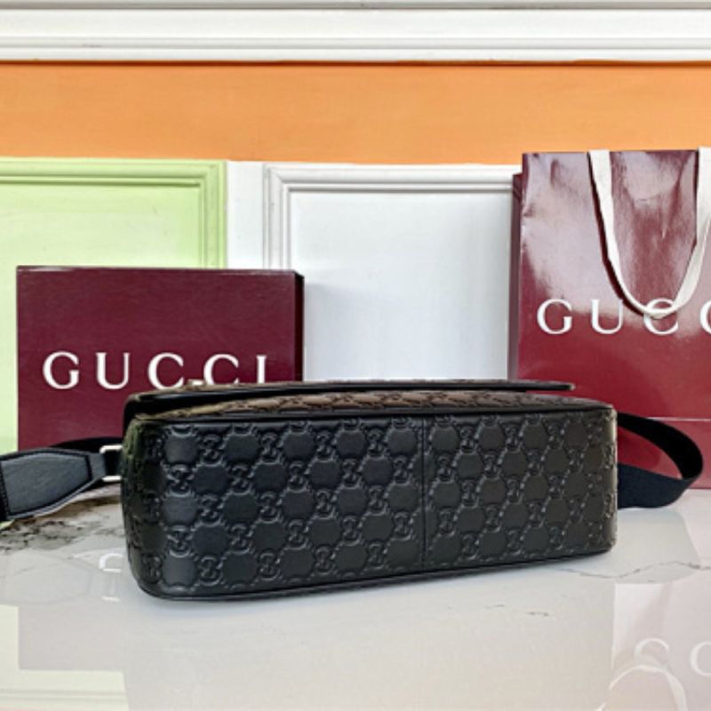 Gucci GG Emblem Medium Crossbody Bag in black embossed GG leather.