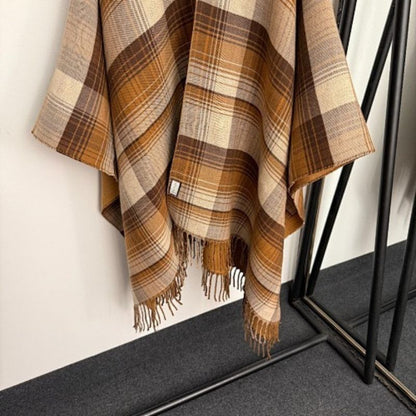 Gucci Reversible GG Wool Poncho in a camel and brown colorway.