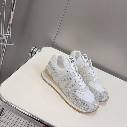 Miu Miu x New Balance 574 crystal-embellished sneakers.