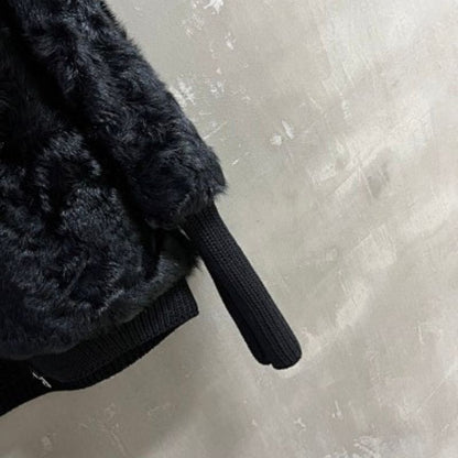 Christian Dior  faux-fur jacket featuring contrasting black knit sleeves, collar, and hem
