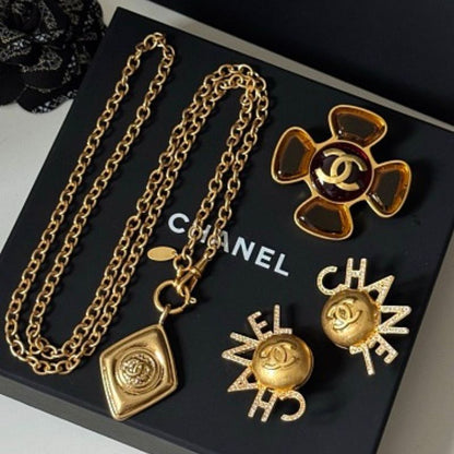 Chanel jewelry presented on a black Chanel gift box.