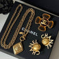 Chanel jewelry presented on a black Chanel gift box.