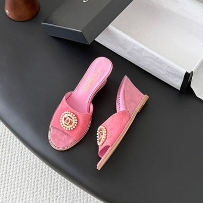 Chanel Pearl-Embellished Interlocking CC Suede Mules in bright pink.
