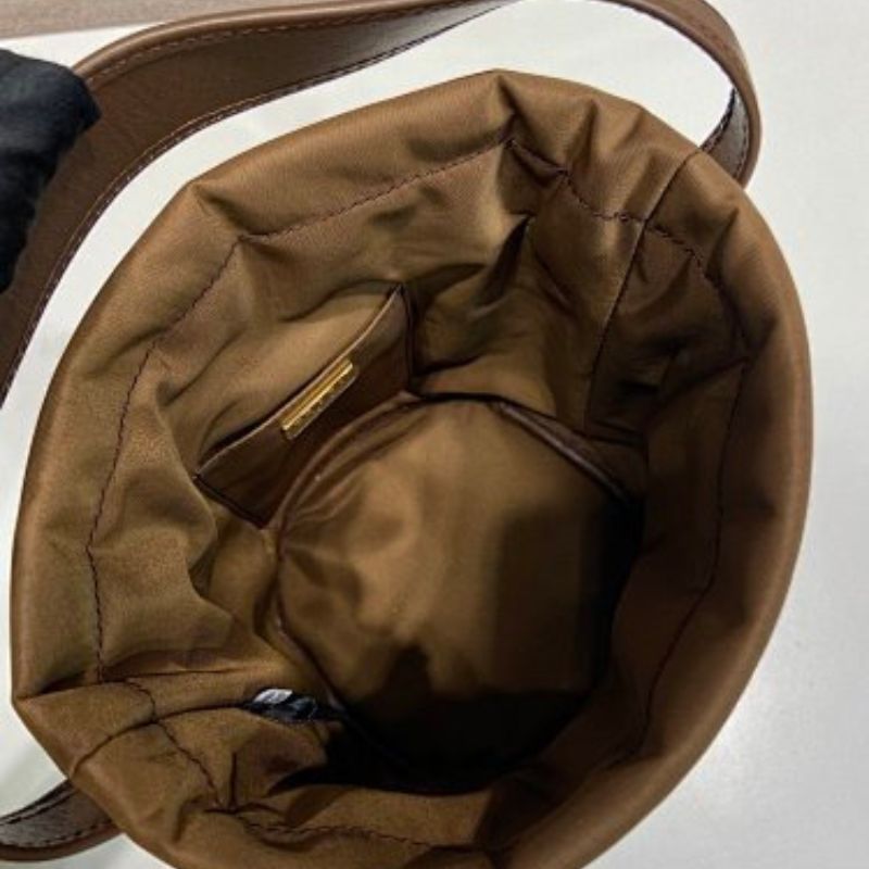 Prada Arqué Re-Nylon and Leather Bucket Bag in a rich cocoa brown.