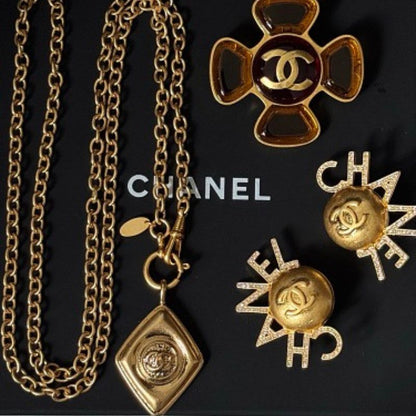 Chanel jewelry presented on a black Chanel gift box.