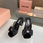 Miu Miu black patent-leather mules or sandals,