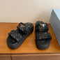 Prada Matelassé Nappa Leather Flatform Slides in black.