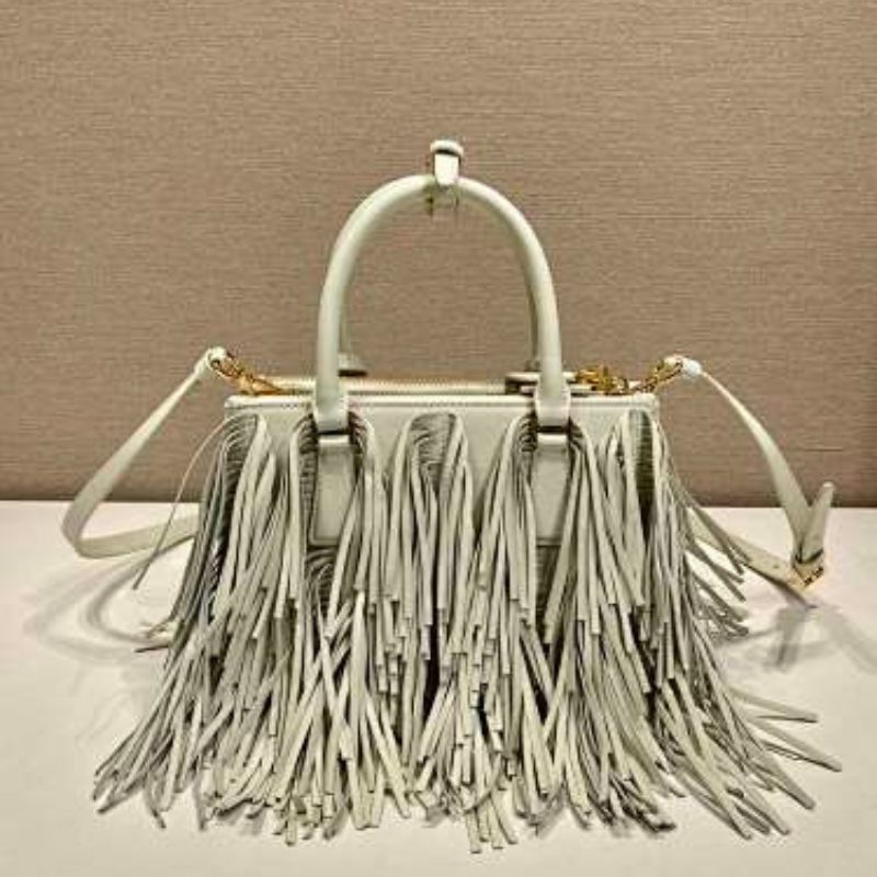 Prada Arqué Fringe Leather Handbag in a light off-white shade.