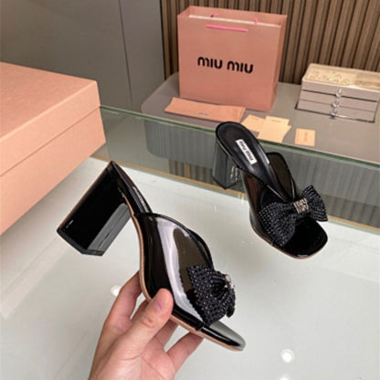 Miu Miu black patent-leather mules or sandals,