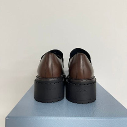 Prada Chocolate Brushed Leather Loafers in a deep ebony dark brown ("Ebano") colorway.