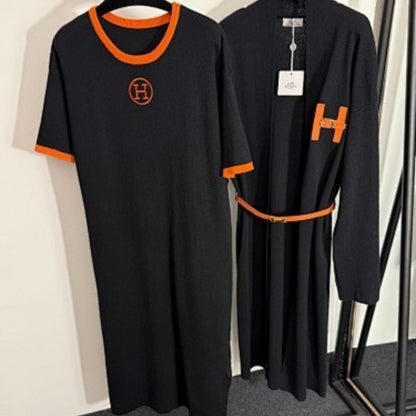 black t-shirt dress and long cardigan set with orange trim and "H" logos.