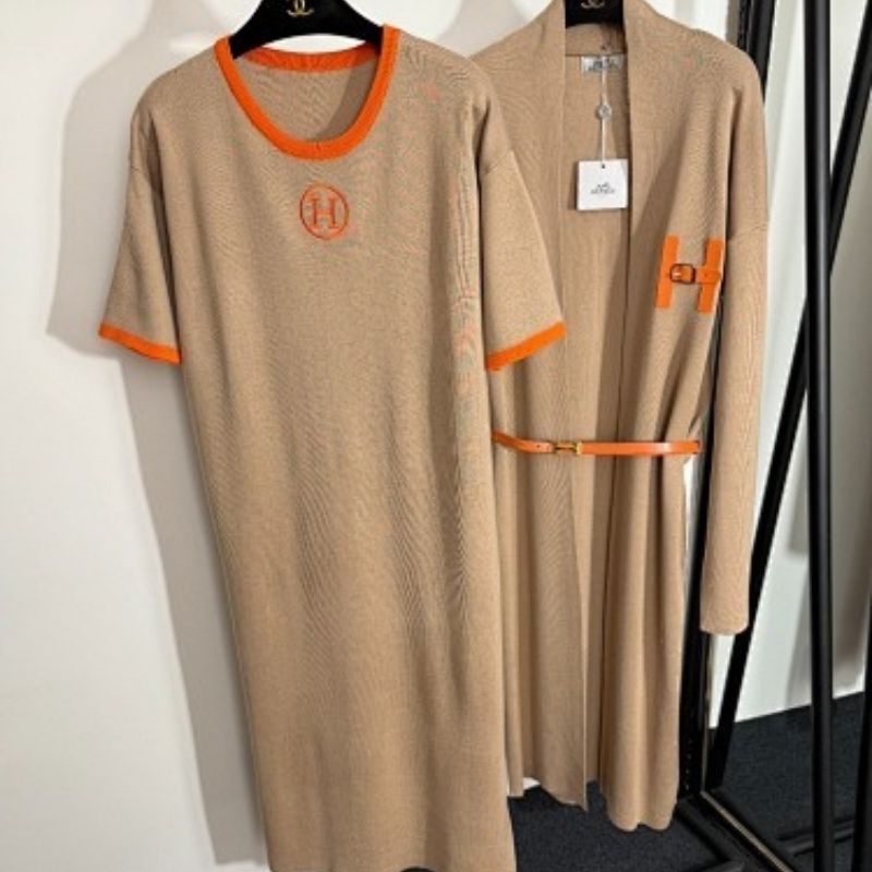 black t-shirt dress and long cardigan set with orange trim and "H" logos.