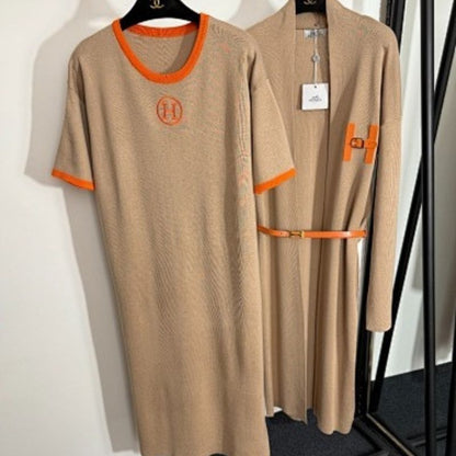 black t-shirt dress and long cardigan set with orange trim and "H" logos.