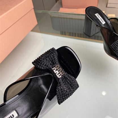 Miu Miu black patent-leather mules or sandals,