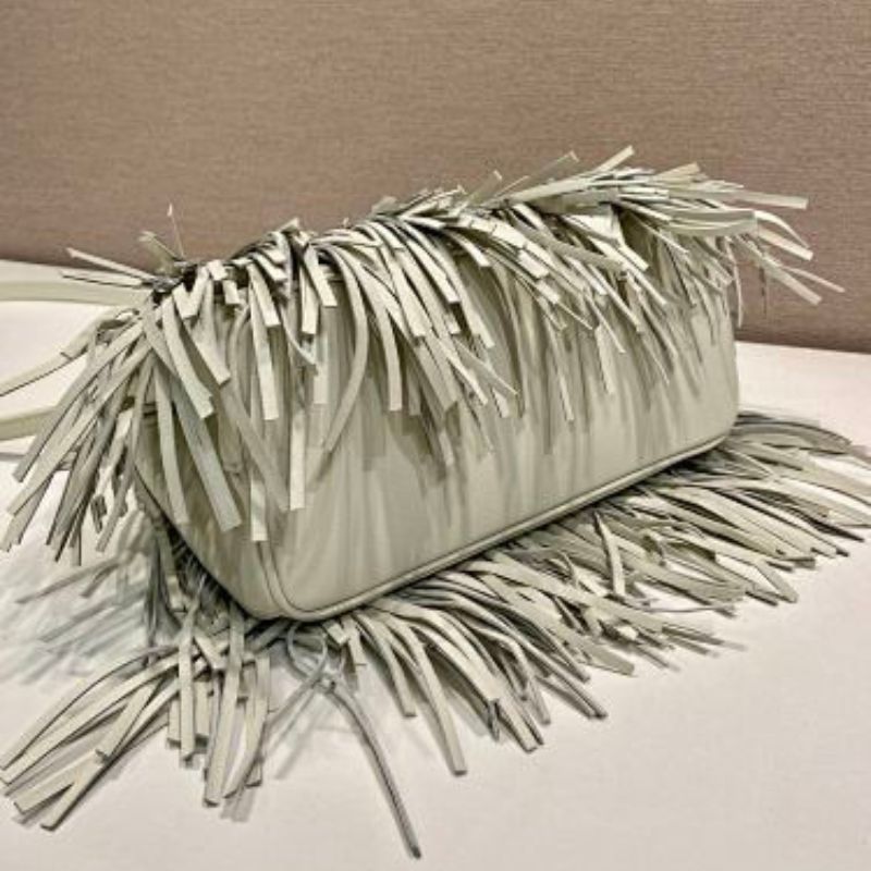 Prada Arqué Fringe Leather Handbag in a light off-white shade.