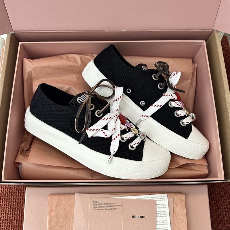 Miu Miu Washed Denim Sneakers.