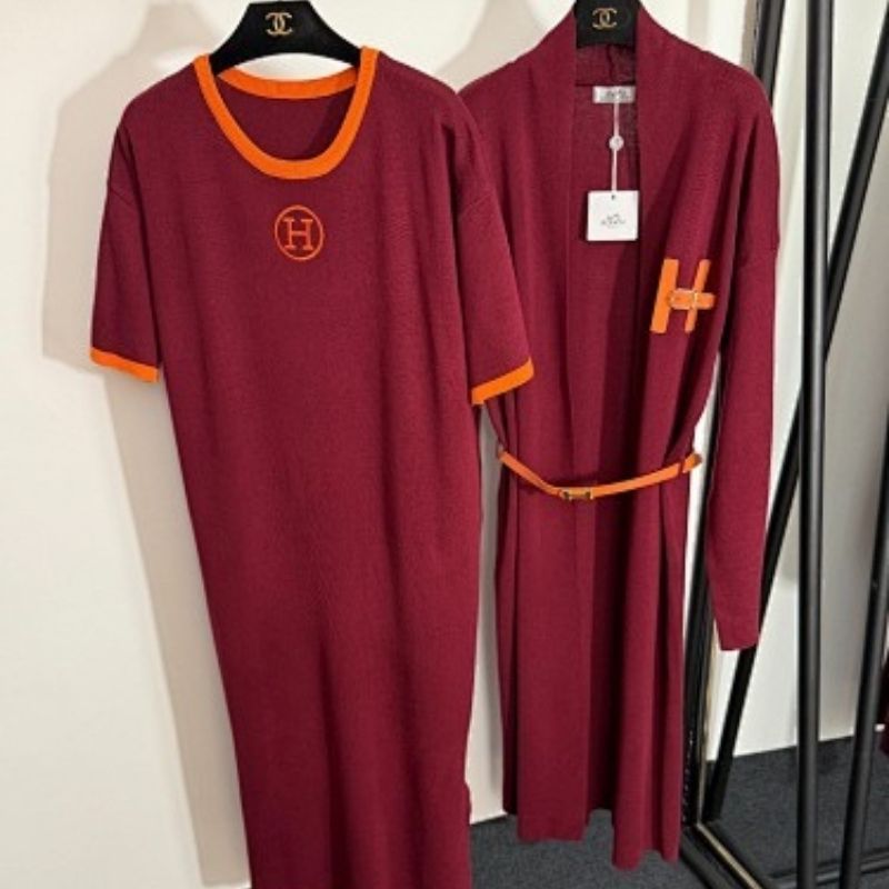 black t-shirt dress and long cardigan set with orange trim and "H" logos.