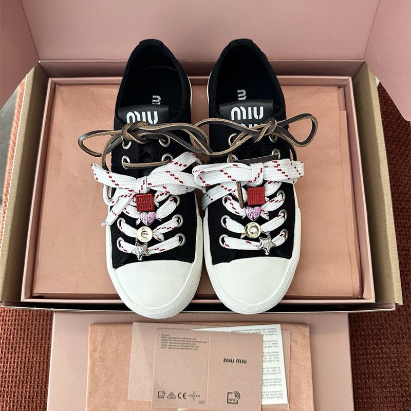 Miu Miu Washed Denim Sneakers.