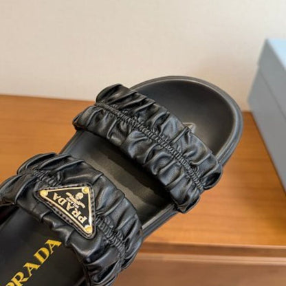 Prada Matelassé Nappa Leather Flatform Slides in black.