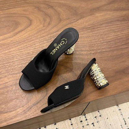 Chanel Ribbed Knit Open-Toe Mules in black.