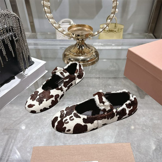 Miu Miu ballet flats with a cow print design