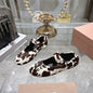Miu Miu ballet flats with a cow print design