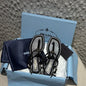 Prada Patent Leather T-Strap Enameled Triangle Logo Sandals.