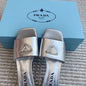 Prada Metallic Leather Flat Slide Sandals in silver.