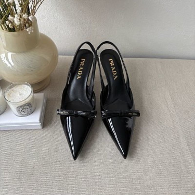 Prada Vernice Patent Leather Bow Slingback Pumps in black.