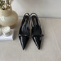 Prada Vernice Patent Leather Bow Slingback Pumps in black.