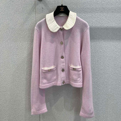 Chanel-style pink knitted cardigan with a white Peter Pan collar