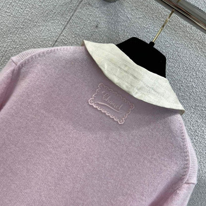 Chanel-style pink knitted cardigan with a white Peter Pan collar