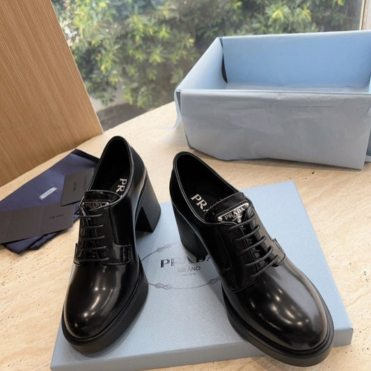 Prada Heeled Brushed Leather Lace-Ups in Black