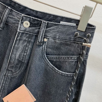 Miu Miu  dark wash, wide-leg denim jeans with a chain detail.