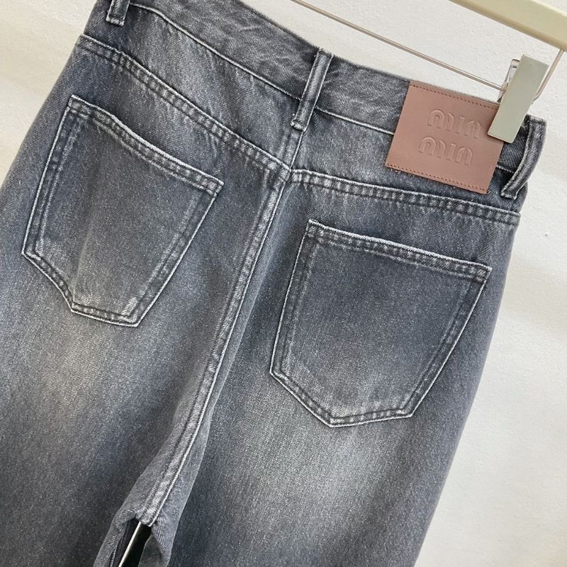 Miu Miu  dark wash, wide-leg denim jeans with a chain detail.