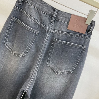 Miu Miu  dark wash, wide-leg denim jeans with a chain detail.