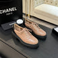 Chanel two-tone platform lace-up shoes.