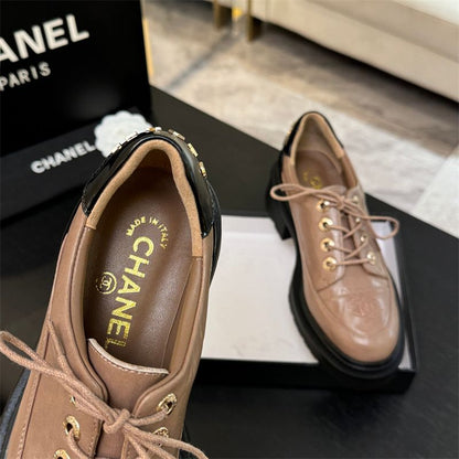 Chanel two-tone platform lace-up shoes.