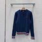 Miu Miu navy blue cable-knit sweater.
