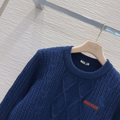 Miu Miu navy blue cable-knit sweater.