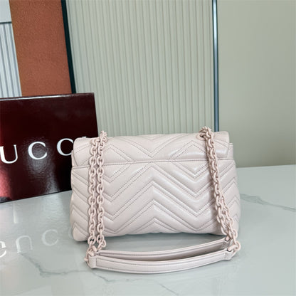 Gucci GG Marmont Small Matelassé Shoulder Bag in a light pink hue.