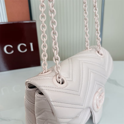 Gucci GG Marmont Small Matelassé Shoulder Bag in a light pink hue.