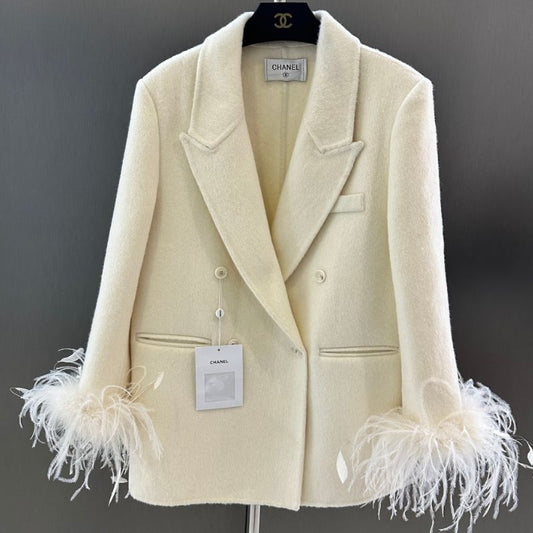 Chanel-style double-breasted blazer with feather cuffs.