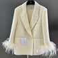 Chanel-style double-breasted blazer with feather cuffs.