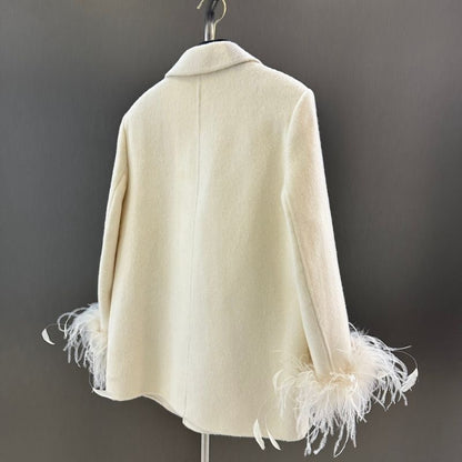Chanel-style double-breasted blazer with feather cuffs.